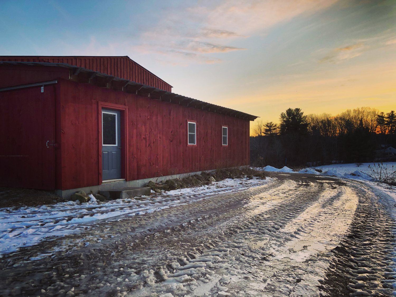 Red farm building in winter light